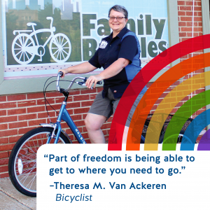 Theresa poses with a bike in front of her bike shop