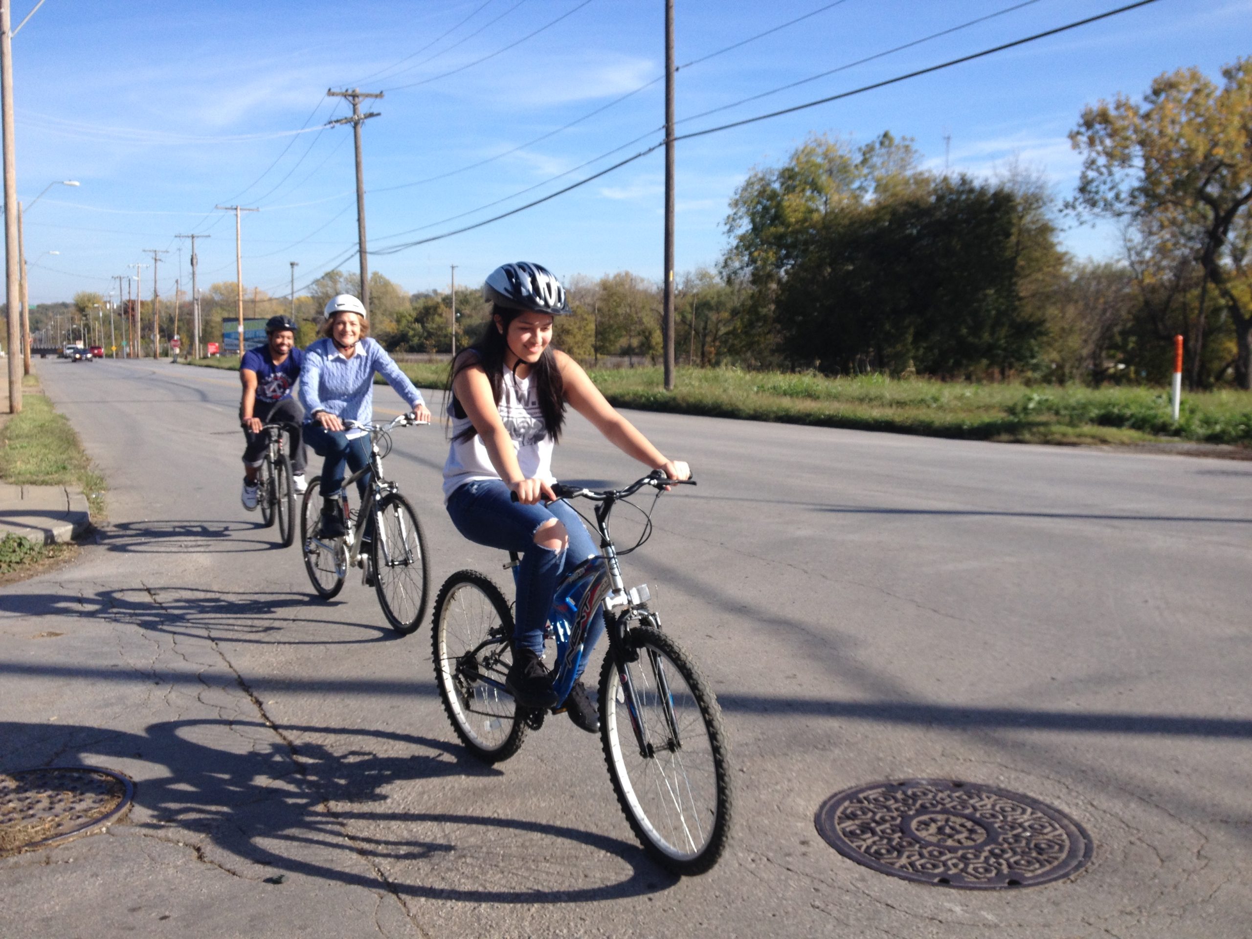 KCPS School Board members Matthew Oates and Patty Mansur ride with East High School Bike Club