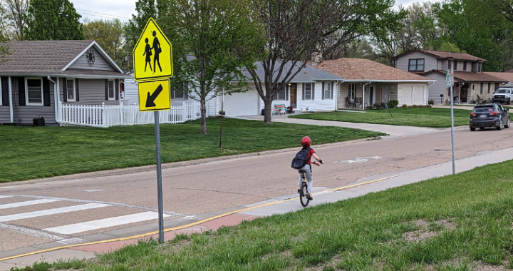 A child rides a unicycle to school in Topeka