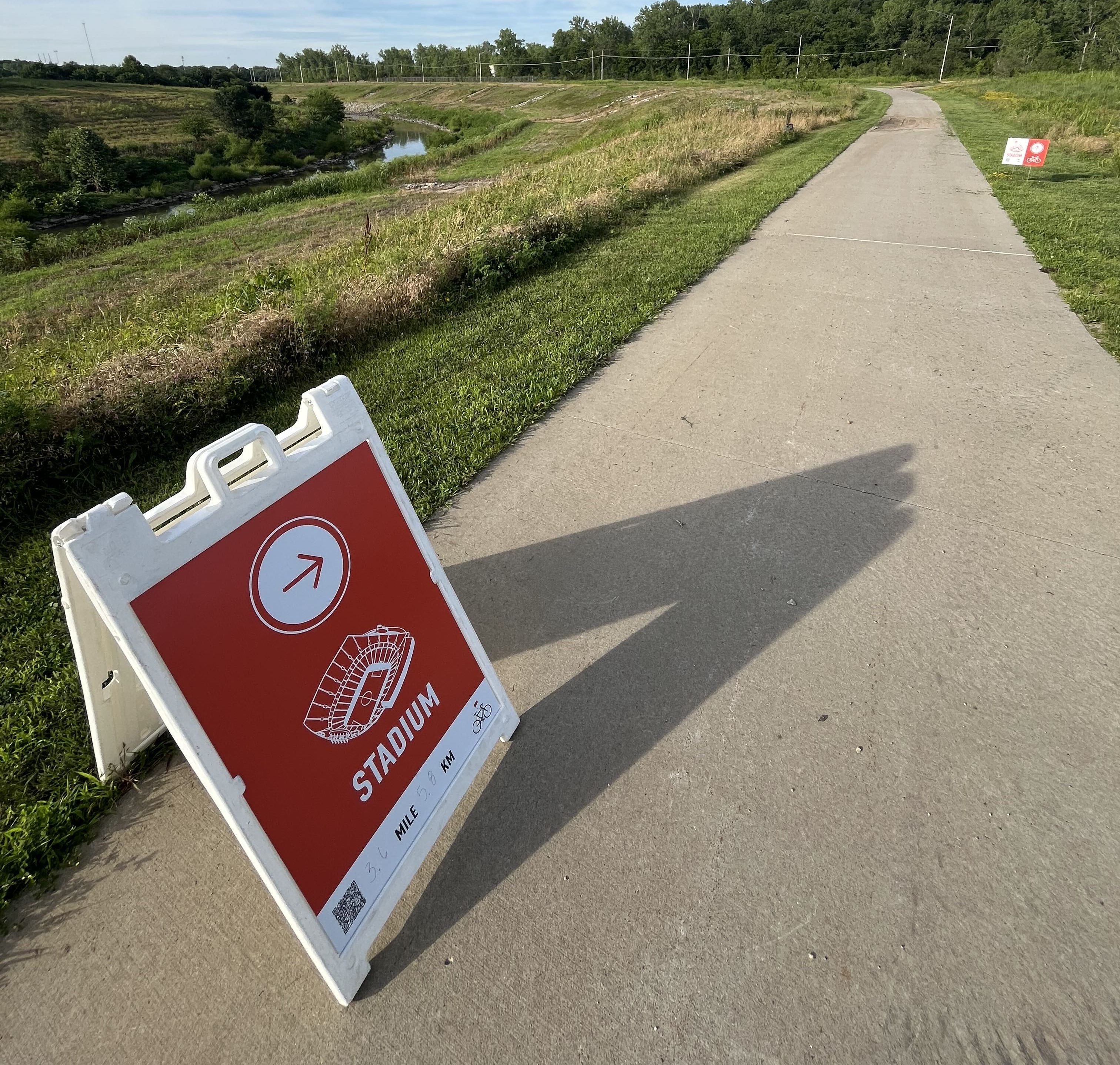 A sign on the Blue River Trail points riders towards KC Stadium