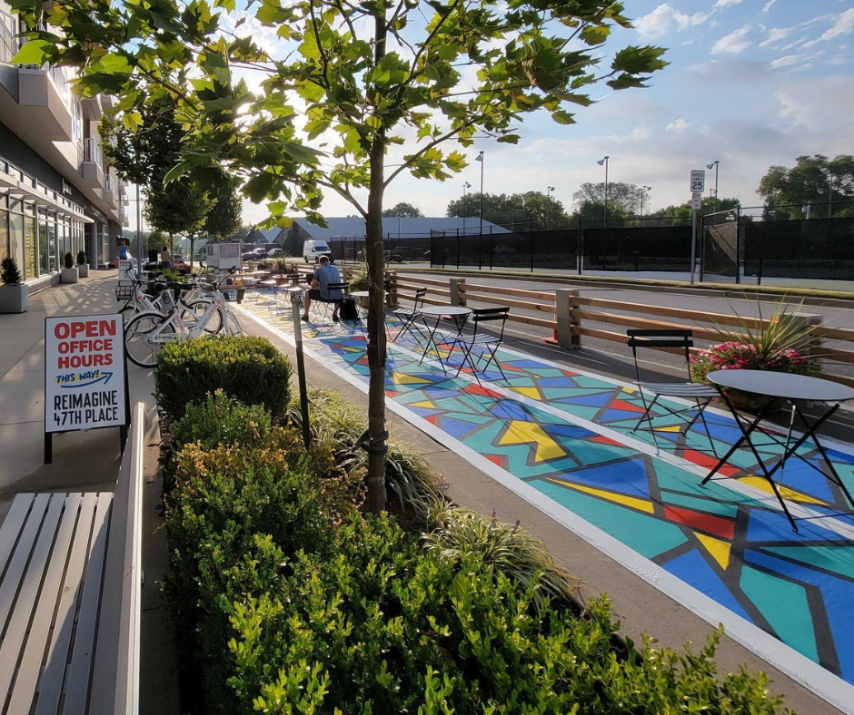 A temporary parklet slows down drivers, beautifies the street, and provides a colorful place for people to rest.